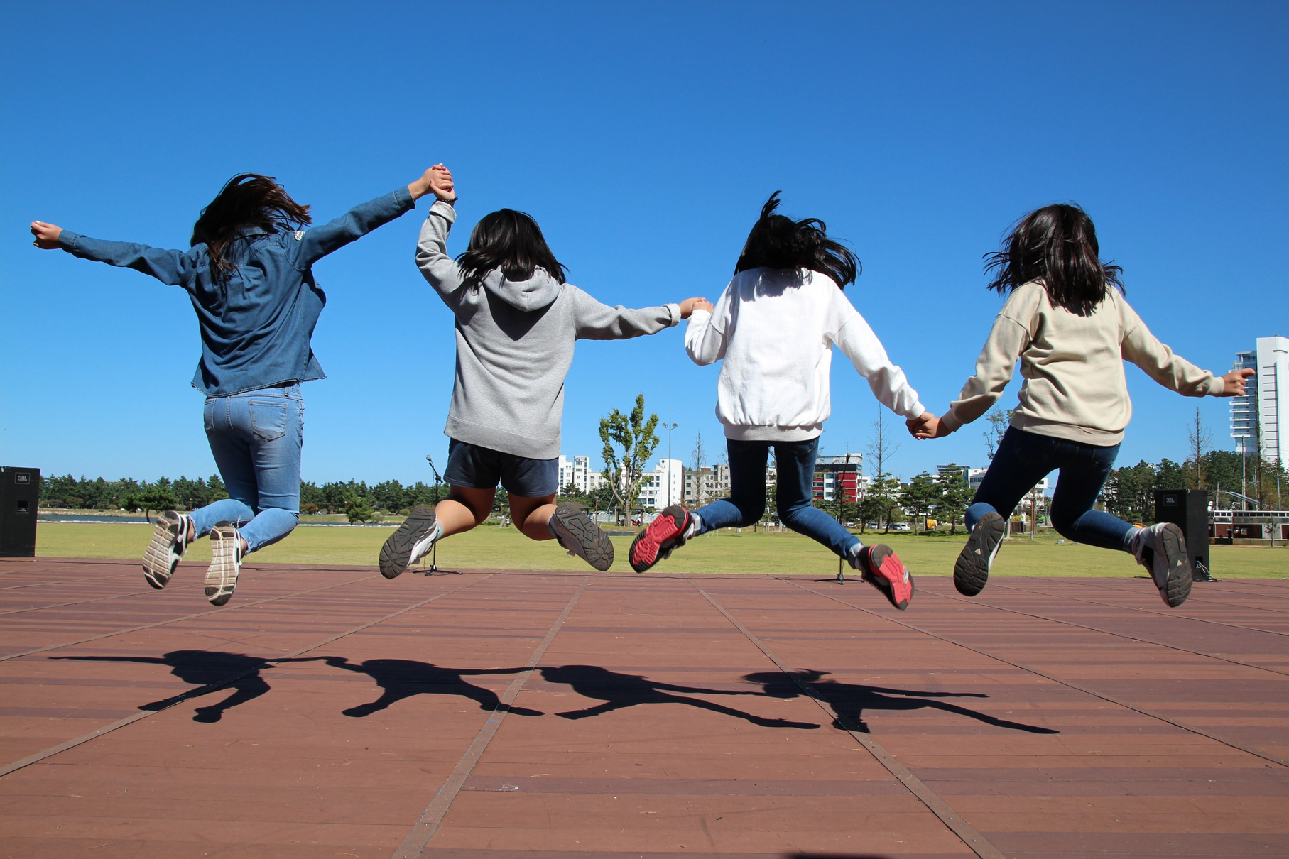 Children Jumping Together Outsdoors
